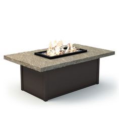 an outdoor fire pit sitting on top of a cement table with flames coming out of it