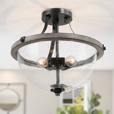 a ceiling light with three lights on it in a living room or dining room area