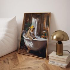 a framed photograph of a leopard sitting in a bathtub next to a lamp and books