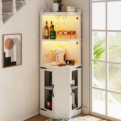 a white cabinet with wine bottles and glasses on it next to a stair case in a living room