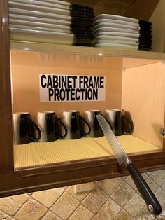 there is a cabinet that has some black and white plates on it with the words cabinet frame protection