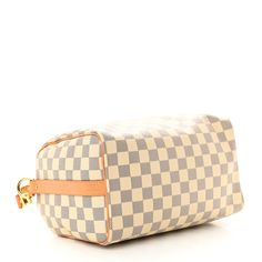 This is an authentic LOUIS VUITTON Damier Azur Speedy Bandouliere 25. This stylish handbag is crafted of Louis Vuitton's signature Damier checkered canvas in blue and white. The bag features rolled vachetta leather top handles, an optional shoulder strap, and matching trim, accented with polished brass hardware. The top zipper opens to a beige fabric interior with a hanging zipper pocket. Damier Azur Speedy, Speedy Bandouliere 25, Speedy Bandouliere, Louis Vuitton Damier Azur, Beige Fabric, Brass Hardware, Polished Brass, Leather Top, Authentic Louis Vuitton