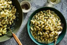 two bowls filled with macaroni and cheese on top of a table