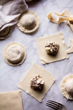 small pastries are sitting on top of paper napkins and next to a fork