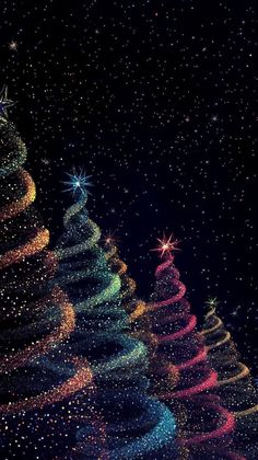 three christmas trees are lit up in the night sky with stars on them and sparkles all around