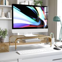 a desktop computer monitor sitting on top of a desk next to a keyboard and mouse