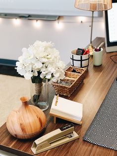 a wooden table topped with a vase filled with white flowers