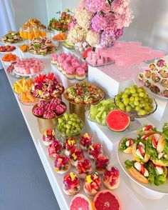 a buffet table filled with lots of different types of foods and desserts on it