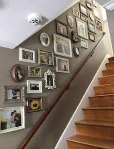 a staircase with pictures on the wall next to it