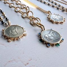 A fabulous find! This traditional piece can be paired with any outfit or worn as a layered necklace. Customize this fabulous equestrian pendant necklace to fit your style or for the horse lover in your life! ⭐️Coin with Bezel size: 40mm ⭐️Bezel made of Brass ⭐️Coin made of Zinc Alloy Design your necklace! 🌙1) Choose your coin: A-E gold bezel w/ gems & silver coin, 🌙2) Choose a chain: Chains 1-6 include a Spring Clasp (allowing the chain to be worn with other pendants). As seen in picture 8. Ch Artisan Necklace With Charms And Round Pendant, Heirloom Sterling Silver Charm Necklaces, Artisan Necklace With Round Pendant Charms, Heirloom Silver Necklaces With Charms, Heirloom Necklaces With Charms, Heirloom Silver Necklace With Charms, Heirloom Round Charm Necklaces, Heirloom Medallion Necklace With Charms, Elegant Gold Jewelry With Horse Design