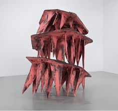 an abstract sculpture with red paint on it