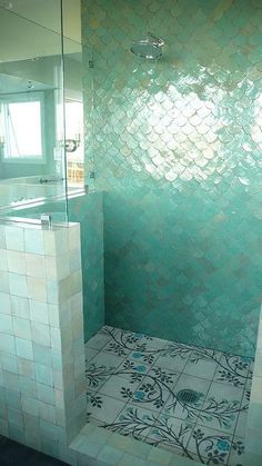 a bathroom with a tiled floor and walls in the shower area, along with a walk - in shower