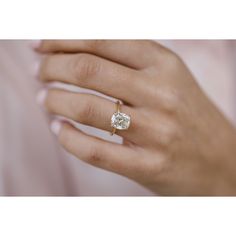 a woman's hand with a diamond ring on it