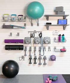 there is a gym ball, exercise equipment and other items on the wall in this room