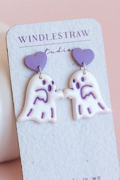 Adorable shimmering white ghosts, featuring a pastel heart stud! Available in pink or purple. These are so cute for both Halloween and Valentine's day. Handmade in Western Australia. These ghosties have been carefully buffed to a lovely shiny finish - no resin used. Earring posts are embedded into clay (see images) for extra durability. Made with silver electroplated jump rings and stainless steel ear posts. Earring backs are silicone.  Each earring measures approximately: 35mm total length 25mm White Novelty Jewelry For Valentine's Day, Novelty White Jewelry For Valentine's Day, Valentine's Day White Novelty Jewelry, Whimsical White Jewelry For Valentine's Day, Fun White Earrings For Valentine's Day, White Heart-shaped Kawaii Jewelry, Kawaii White Heart-shaped Jewelry, Spooky Valentines Day, Spooky Valentines