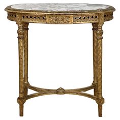 an ornately decorated table with marble top