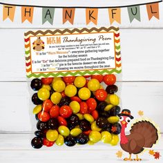 a turkey candy filled with thanksgiving candies in front of a thank you sign on a white wooden background