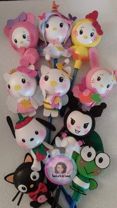 a bunch of hello kitty lollipops sitting on top of a white table