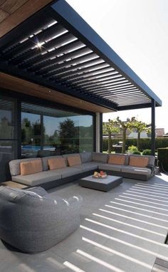 an outdoor living area with couches and tables