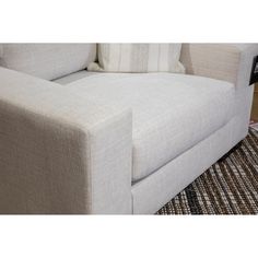 a white couch sitting on top of a rug