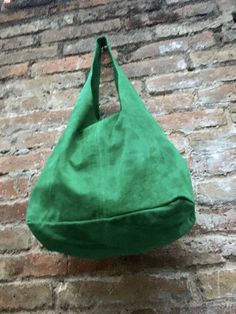 LARGE slouch leather bag in GREEN . Leather tote bag. Natural genuine SUEDE leather. NOT LINED. We added a small leather zipper pouch for your mobile phone and/or cards or money. It ist attached to the inside of the bag by a metal chain. This listing is for the bag in bright GREEN , there is a separate listing in our shop for moss green and also for the dark green bag on the last picture with the model. The bag is closed by a metal clip at the center. Width : 42cm - 16,5 in Height at the center: Green Leather Hobo Bag With Large Capacity, Suede Hobo Travel Bag, Suede Hobo Satchel Bag For Shopping, Soft Suede Hobo Bag For Shopping, Casual Suede Hobo Shoulder Bag, Green Hobo Tote Bag For Daily Use, Green Tote Hobo Bag For Daily Use, Suede Hobo Tote Bag With Large Capacity, Green Leather Hobo Shoulder Bag