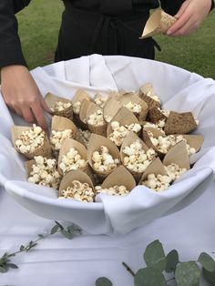 a bowl filled with marshmallows on top of a white cloth covered table