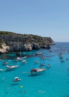 many small boats are in the clear blue water