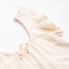 Made from dreamy 100% organic cotton this gauze nightgown has an adjustable neckline drawstring and side slits at the hem to make moving through motherhood easier. 100% organic cotton ruffles at sleeve openings adjustable neckline drawstring to make smaller and bigger side slits at hem lead, phthalate, and flame-retardant free GOTS certified; the leading environmental standard for organic textiles machine wash; tumble dry low Cream Cotton Sleepwear For Relaxation, Feminine Cotton Sleepover Dress, Feminine Cotton Dress For Sleepover, Cotton Dresses For Relaxation, Cotton Ruffled Nightgown For Bedtime, Cotton Ruffled Sleepwear For Bedtime, Feminine Cream Bedtime Dress, Cotton Ruffle Nightgown For Sleepover, Cotton Ruffled Nightgown For Sleepover