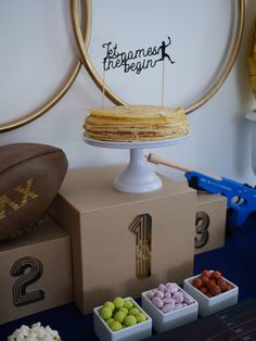 a cake sitting on top of a table next to some snacks and candies in small bowls