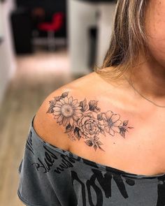 a woman with a sunflower tattoo on her shoulder