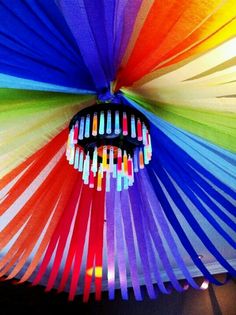 a multicolored umbrella is hanging from the ceiling