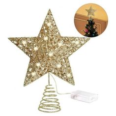 a gold star shaped christmas tree topper next to a white box with a christmas tree in it