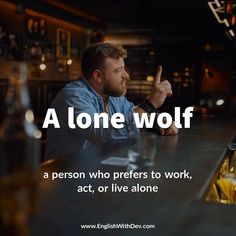 a man sitting at a bar with a beer in his hand and the caption reads, a lone wolf