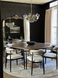 a dining room table with chairs and a chandelier