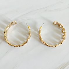 These Linked Golden Hoop Earrings offer a modern and chic twist on traditional hoop earrings. The unique linked design adds a touch of sophistication to any outfit. Elevate your style with these beautifully crafted earrings. Plated alloy metal Lead and Nickel compliant Made in China Golden Hoop Earrings, Crafted Earrings, Golden Hoops, Headband Jewelry, Layered Chain Necklace, Toggle Necklace, Hoop Earrings Gold, Crystal Hoop Earrings, Style Steal