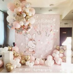 a room with balloons and decorations on the floor, including a large bunny balloon arch