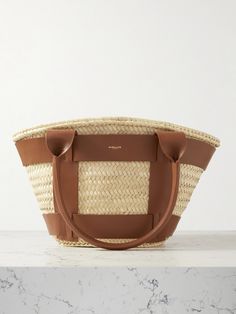 Described by DeMellier as an "elegant summer staple," this 'Santorini' tote has been handwoven by skilled artisans from natural raffia that's overlaid with supple strips of leather. It has an ample interior that'll hold your beach essentials – think your sunscreen, book and water bottle. Floral Dresses Short, Raffia Bag, Beach Essentials, Fine Watches, Summer Staples, Santorini, Leather Working, Net A Porter, Body Bag