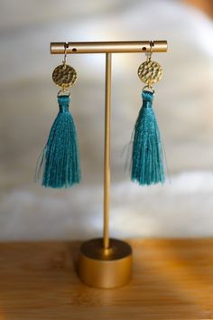 Hammered gold disk with high quality silk rayon 2" tassels, 14k gold fill ear wires. -Designed and assembled in Sonoma, CA Adjustable Handmade Gold Tassel Earrings, Adjustable Handwoven Brass Earrings, Artisan Gold Tassel Earrings, Gold Brass Tassel Earrings, Bohemian Turquoise 14k Gold-filled Earrings, Gold Disc, Hammered Gold, Deep Sea, Tassel Earrings