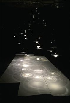 an illuminated dance floor in the middle of a dark room with several lights on it