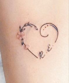 a heart shaped tattoo with the word love written on it