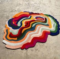 a multicolored rug is laying on the ground