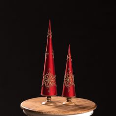 two red cones sitting on top of a wooden table