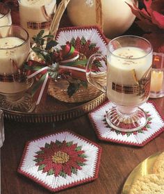 a table topped with plates and cups filled with desserts next to christmas decorations on top of a wooden table