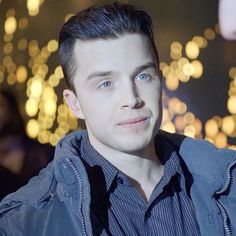 a young man with blue eyes looking at the camera