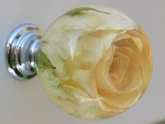 a close up of a door knob with a flower on it