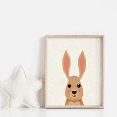 a white star is next to a framed photo with a brown rabbit on it's face