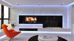 a modern living room with white walls and flooring is lit up by the television