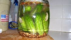 a jar filled with pickles sitting on top of a counter