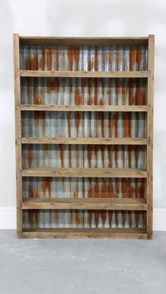 an old wooden shelf with glass bottles on it