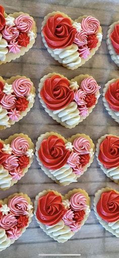 heart shaped cookies with red and white frosting on a table next to each other